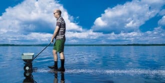 image of man fertilizing the water